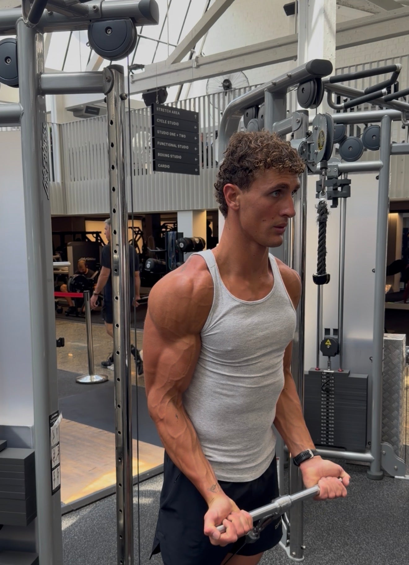 Muscular man in a gym using exercise equipment